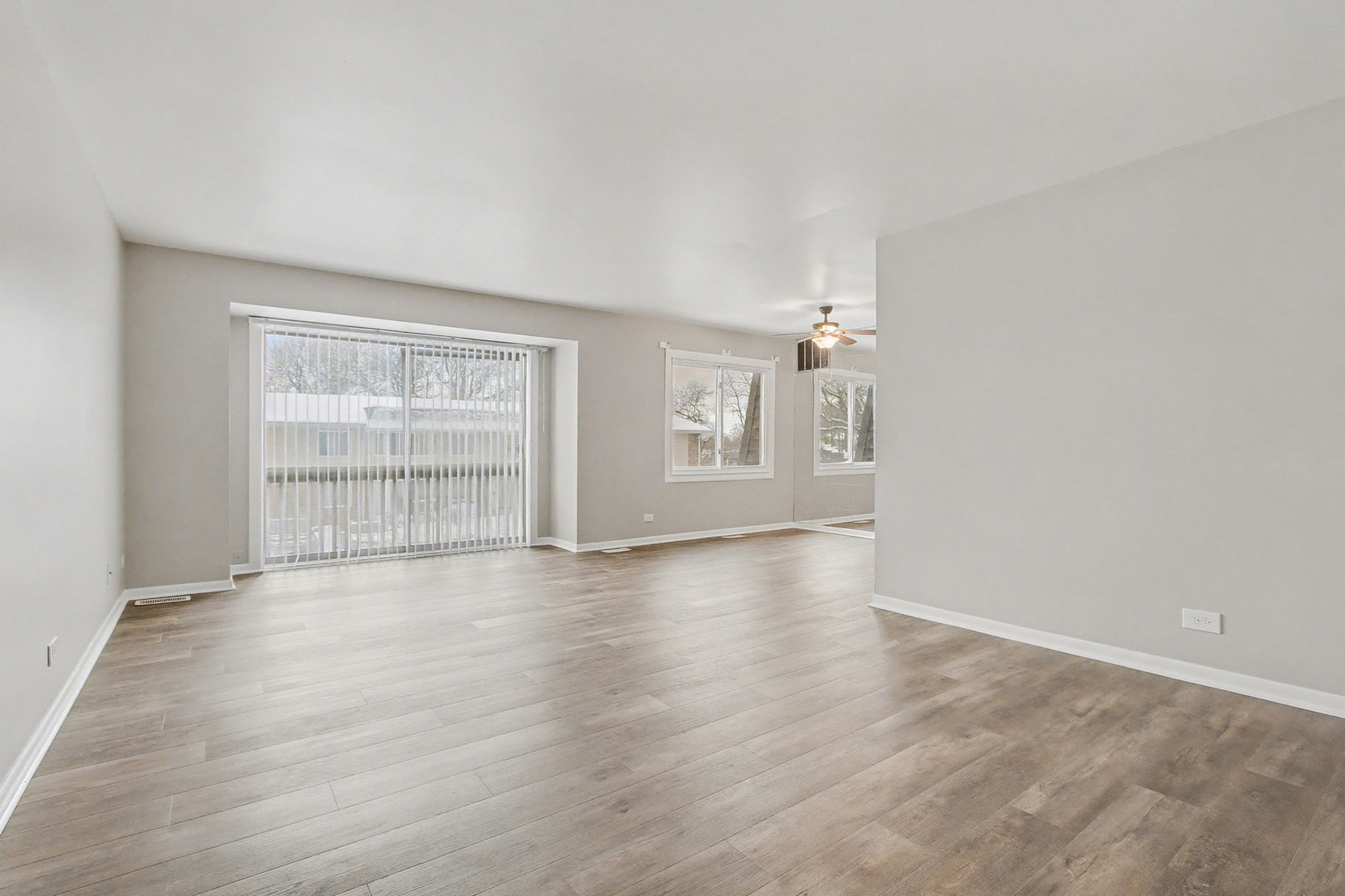 2932 Roberts Drive, Unit 7 Woodridge, IL 60517 - Photo 3 of 28 wooden floor in an empty room with a window