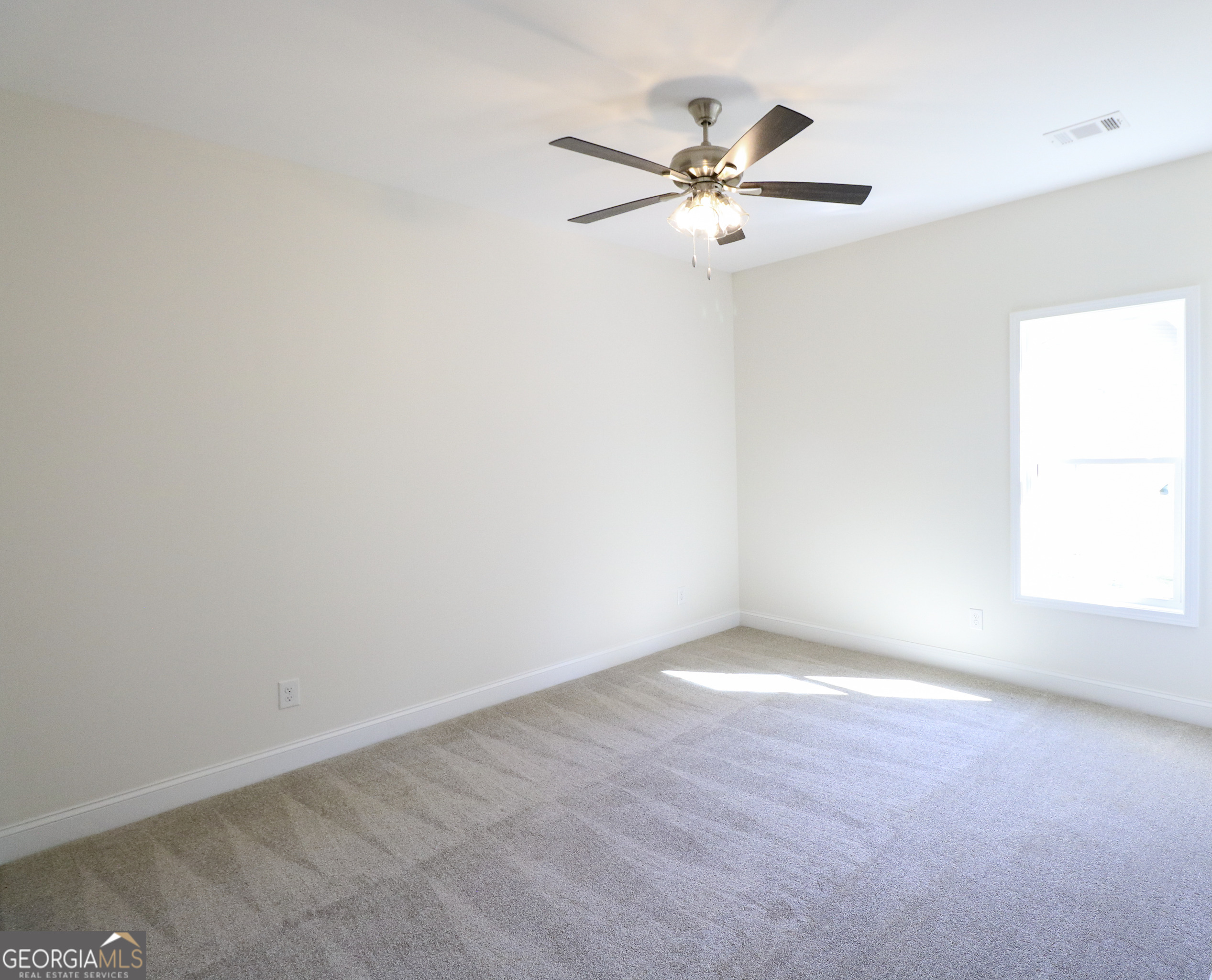 115 Sutter Butte Place Bonaire, GA 31005 - Photo 17 of 38 an empty room with a window and a fan