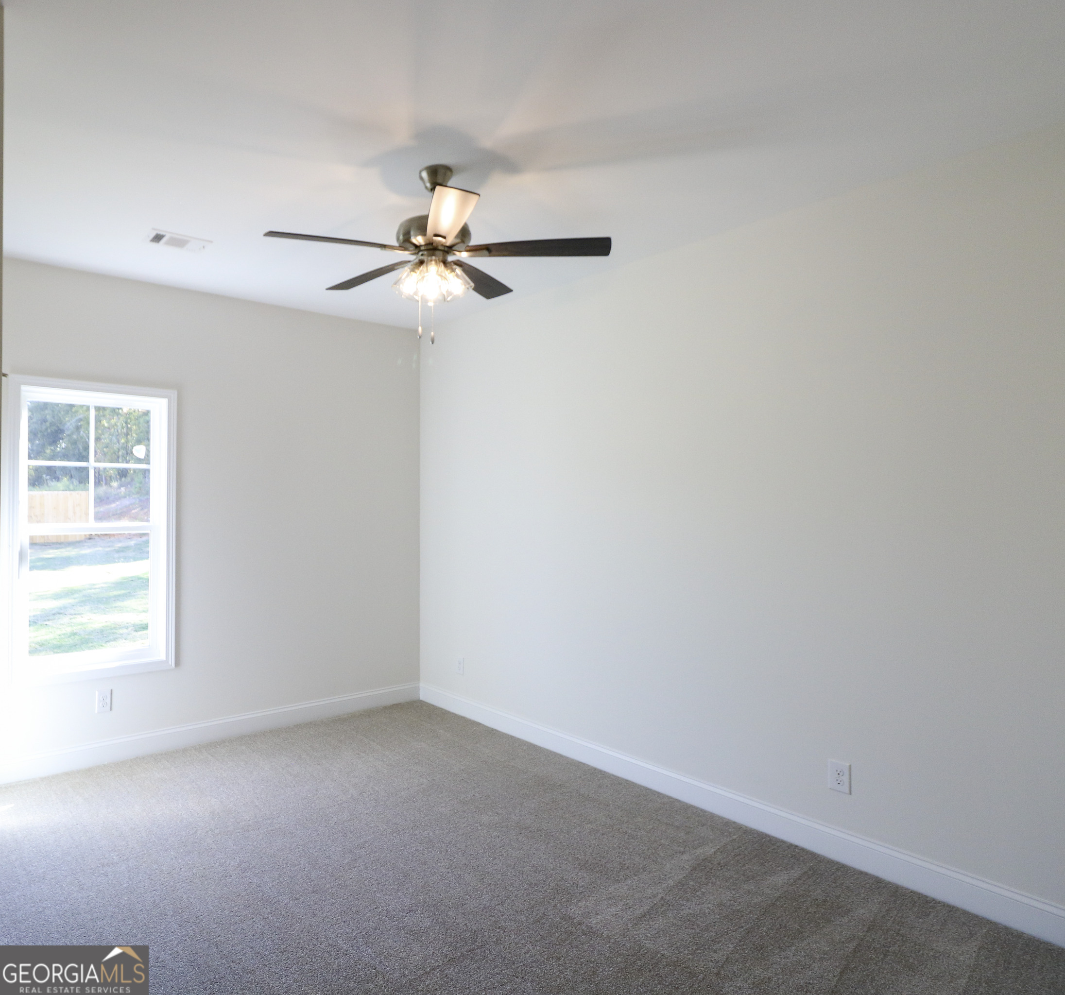 115 Sutter Butte Place Bonaire, GA 31005 - Photo 19 of 38 an empty room with a window and a fan