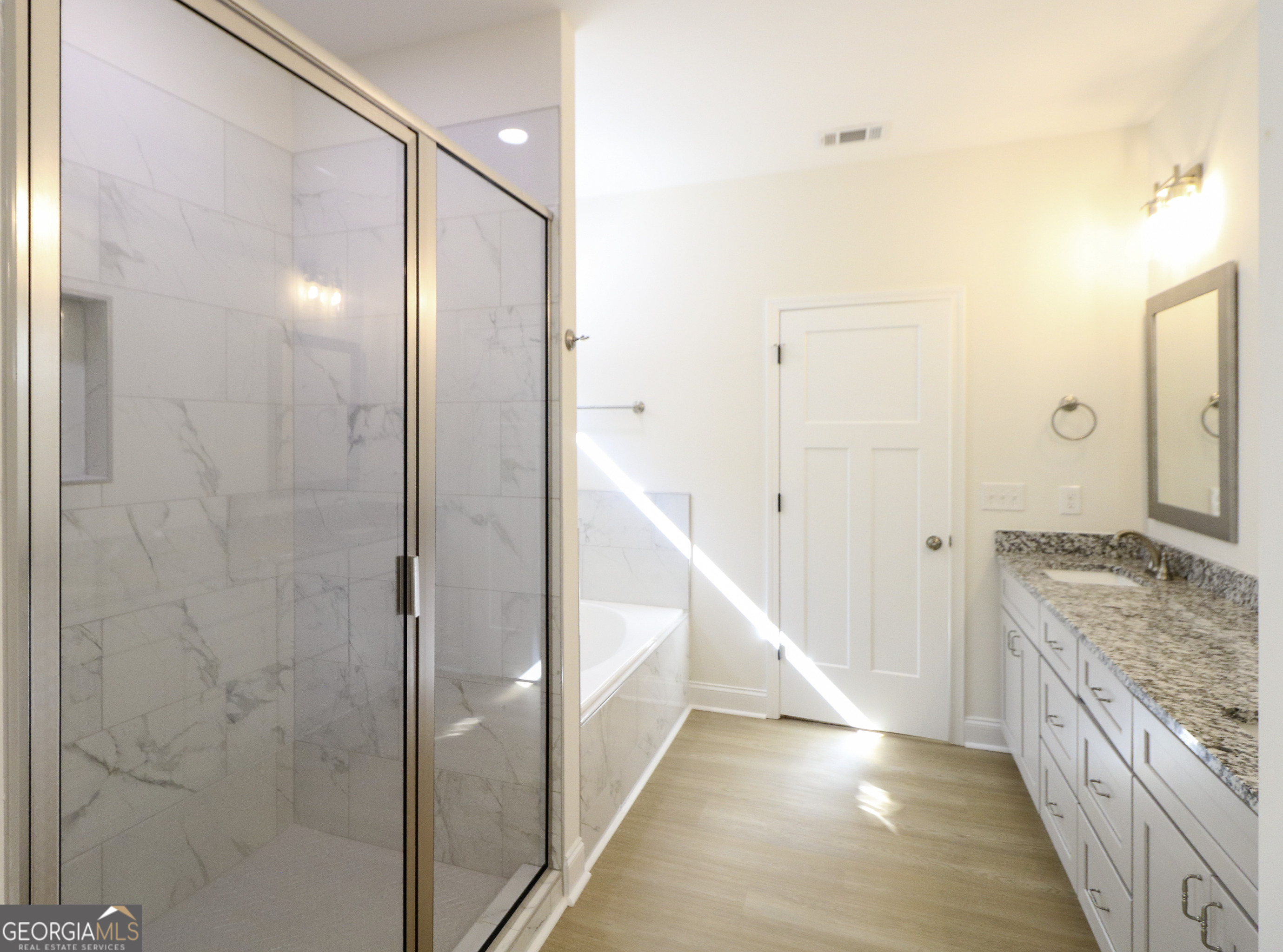 115 Sutter Butte Place Bonaire, GA 31005 - Photo 28 of 38 a bathroom with a granite countertop sink a mirror and a shower