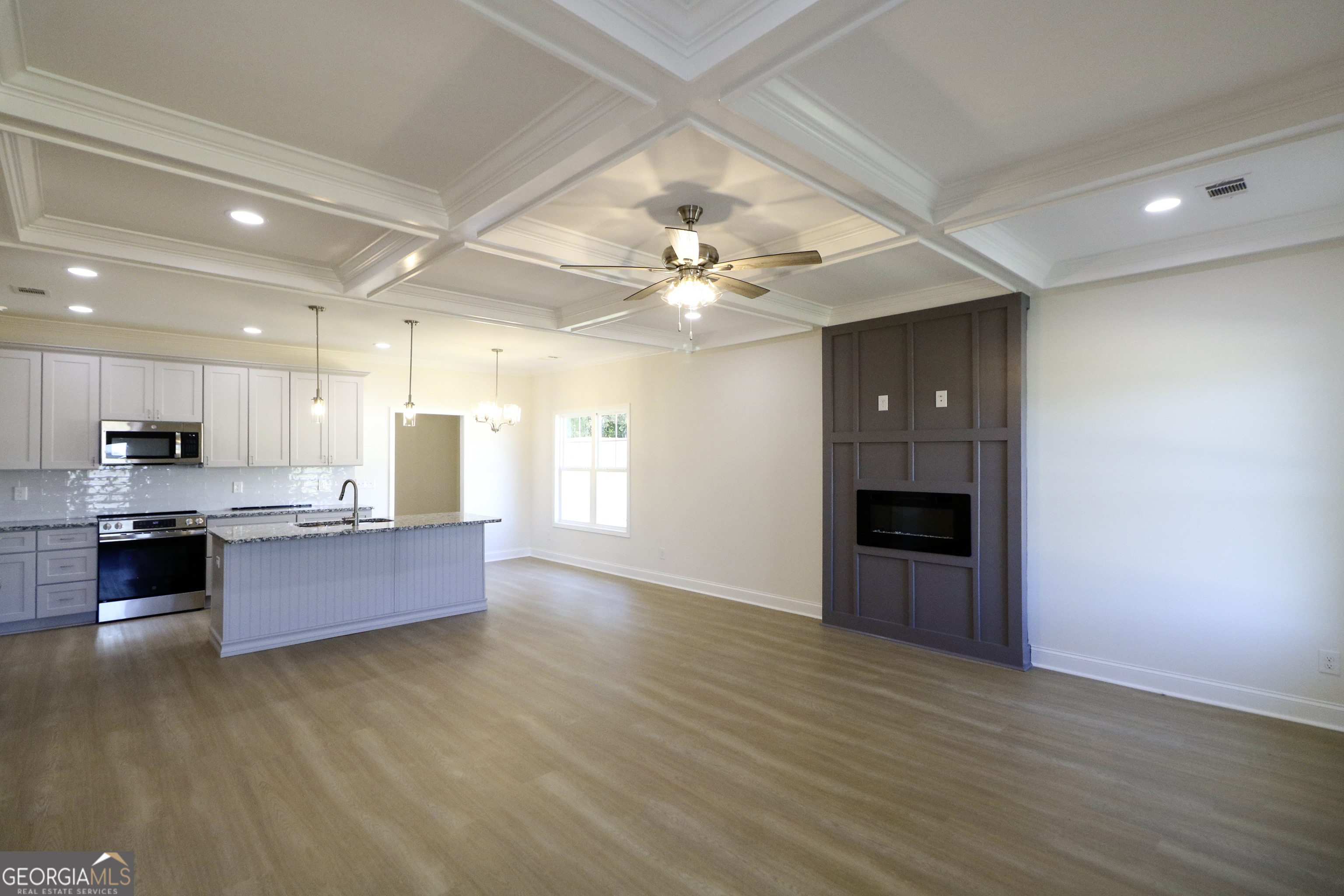 115 Sutter Butte Place Bonaire, GA 31005 - Photo 8 of 38 a large kitchen with stainless steel appliances granite countertop a large counter top and a stove