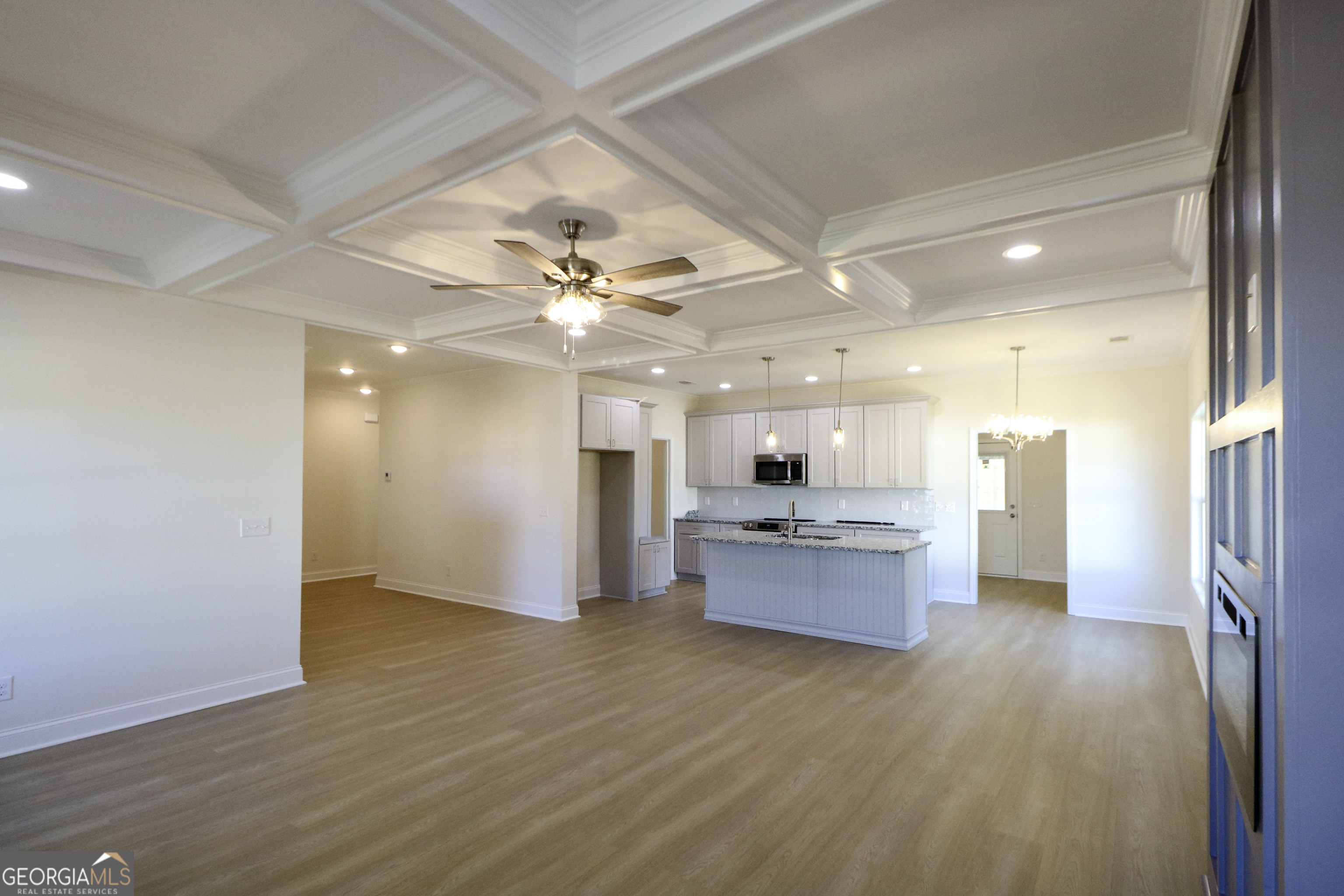 115 Sutter Butte Place Bonaire, GA 31005 - Photo 9 of 38 a view of a kitchen and a chandelier fan wooden floor and a kitchen