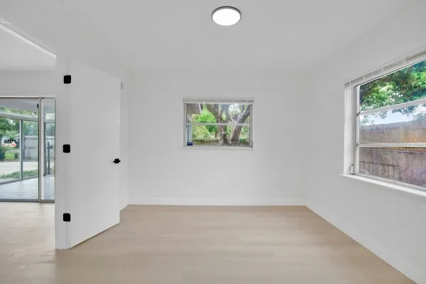 a view of a room with wooden floor and windows