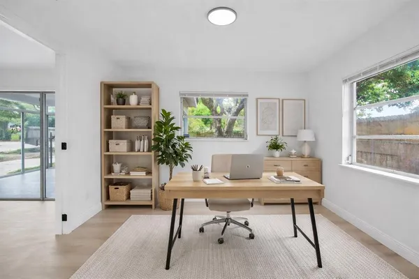 a workspace with furniture and a potted plant
