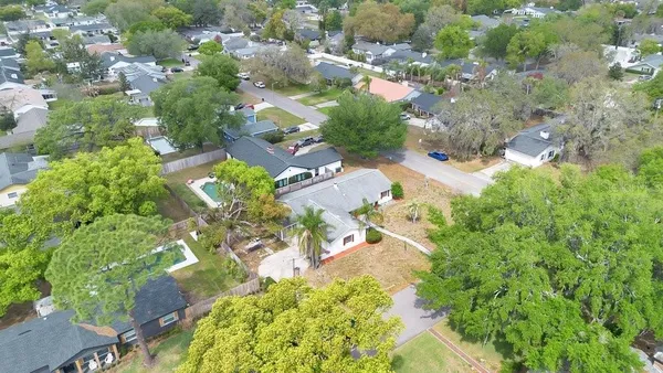an aerial view of a house with a yard