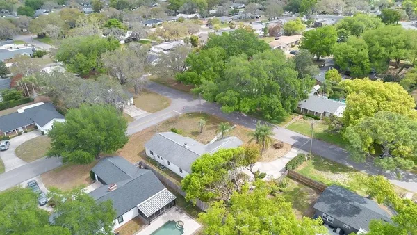 an aerial view of a house with a yard
