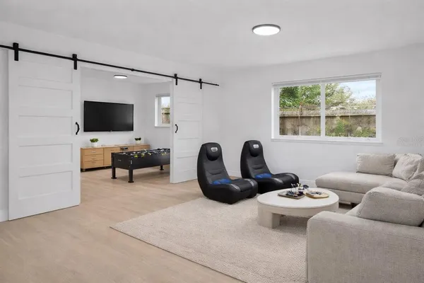 a living room with furniture a ceiling fan and a window