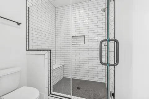 a bathroom with a toilet and a shower