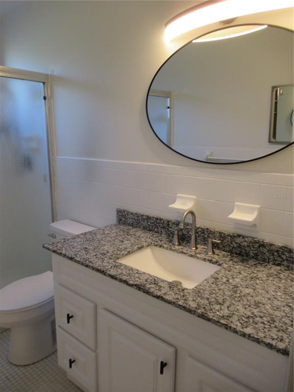 2073 Denmark Street, Unit 5 Clearwater, FL 33763 - Photo 14 of 23 a bathroom with a granite countertop sink and a mirror