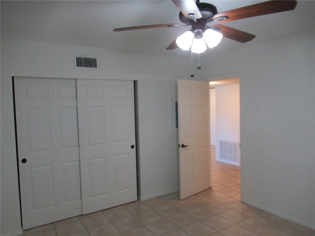 2073 Denmark Street, Unit 5 Clearwater, FL 33763 - Photo 19 of 23 a view of an empty room with a chandelier fan