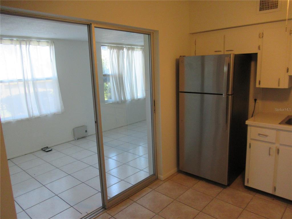 2073 Denmark Street, Unit 5 Clearwater, FL 33763 - Photo 6 of 23 a view of a refrigerator in kitchen and a window in an empty room