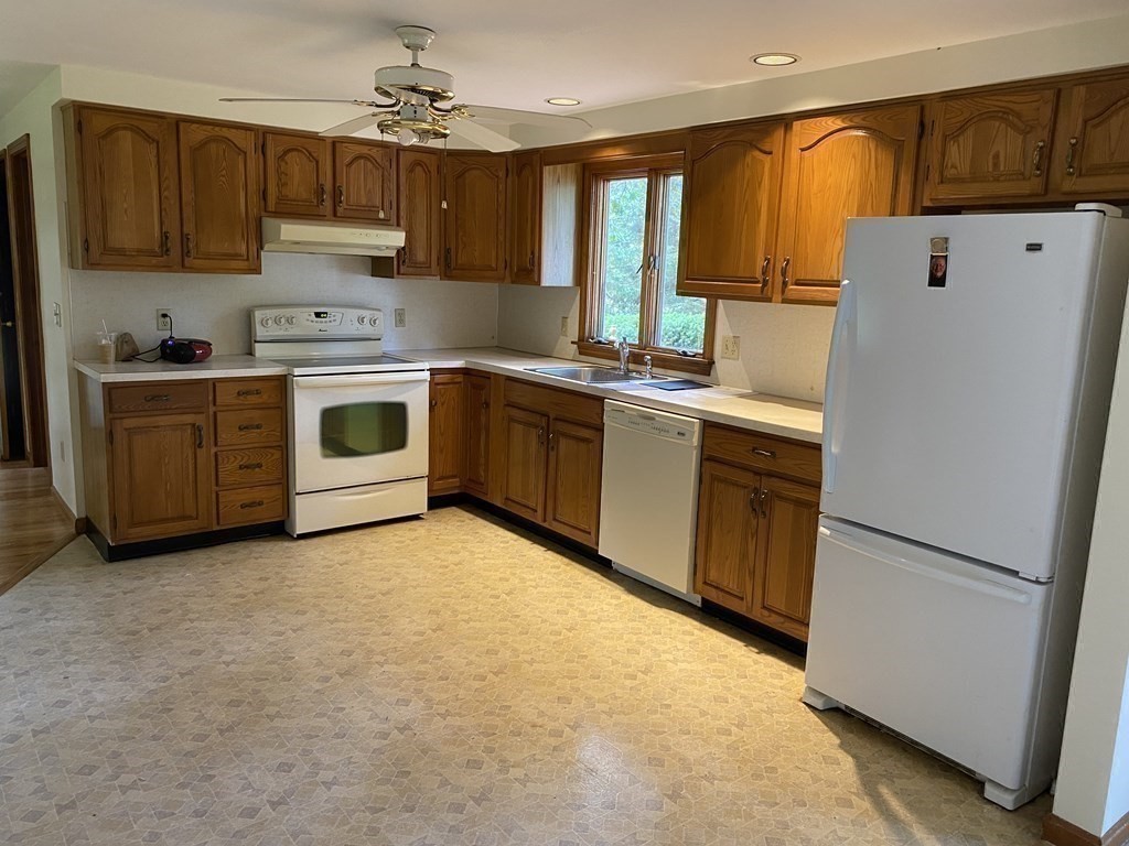 781 Townsend Road Groton, MA 01450 - Photo 13 of 21 a kitchen with a white stove top oven and refrigerator