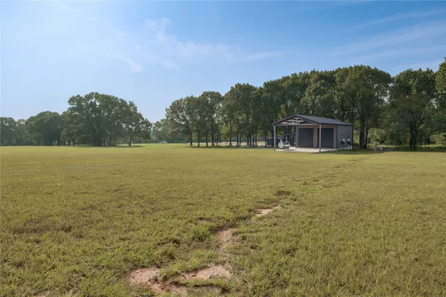 a balcony with outdoor seating and green space