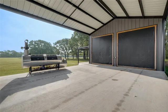a view of a patio with a table and chairs