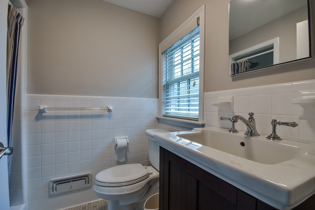 33 Oakridge Road Wellesley, MA 02481 - Photo 19 of 27 a bathroom with a sink a toilet and a mirror