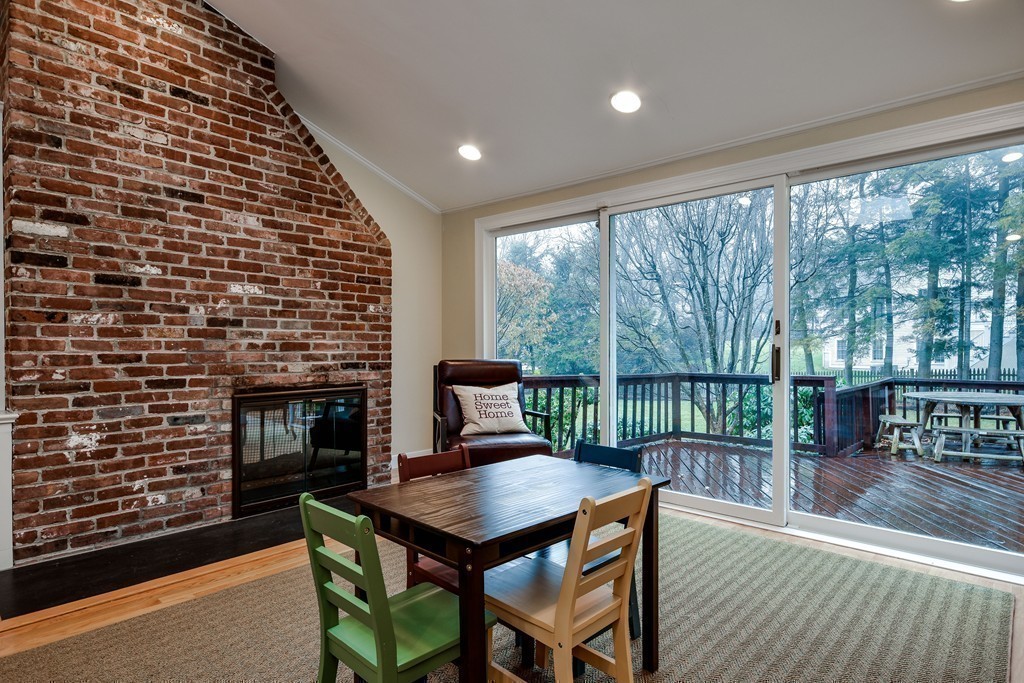 33 Oakridge Road Wellesley, MA 02481 - Photo 9 of 27 a living room with a fireplace and large windows