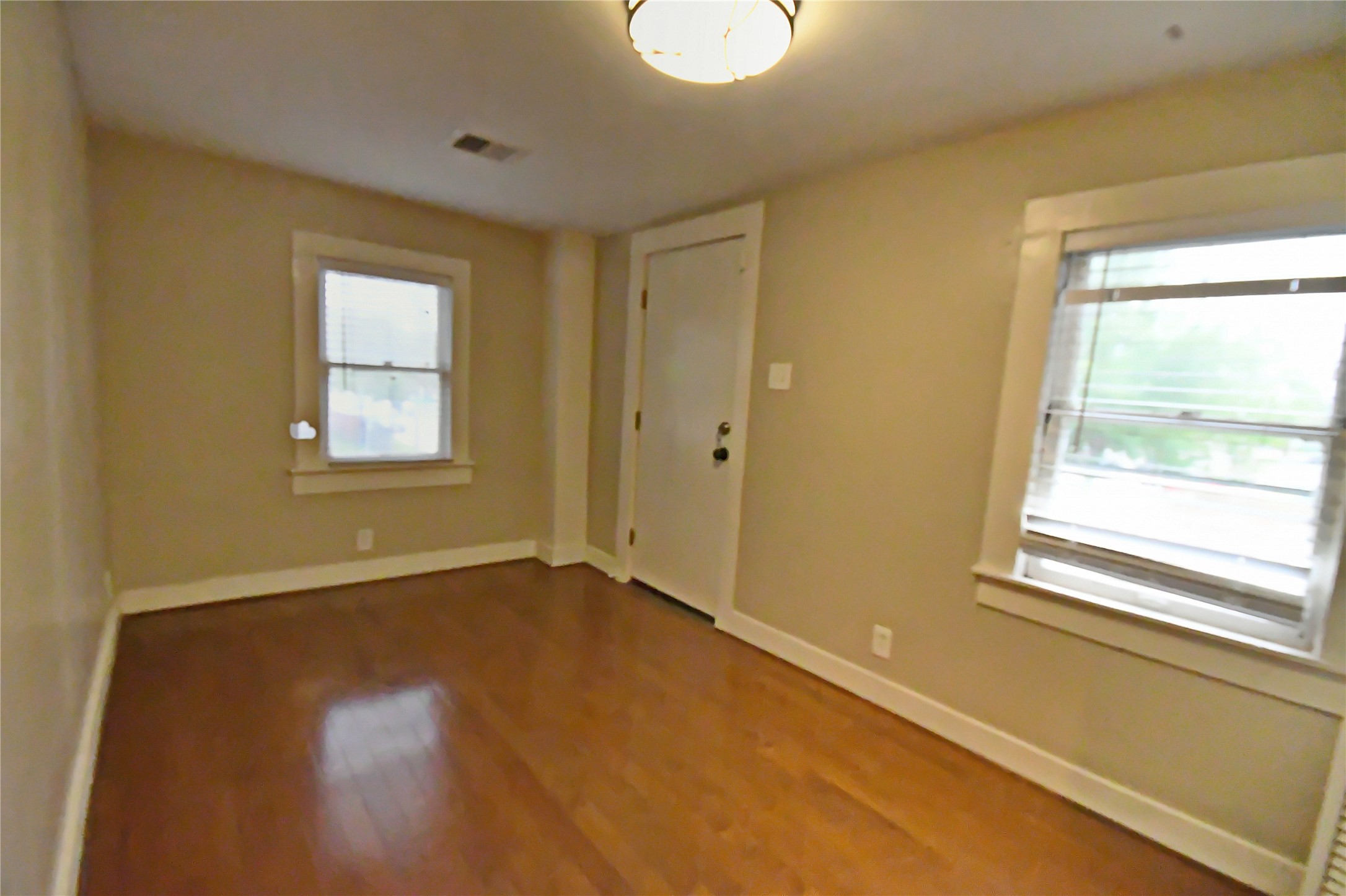 1209 Studewood Street Houston, TX 77008 - Photo 16 of 18 a view of an empty room with wooden floor and a window