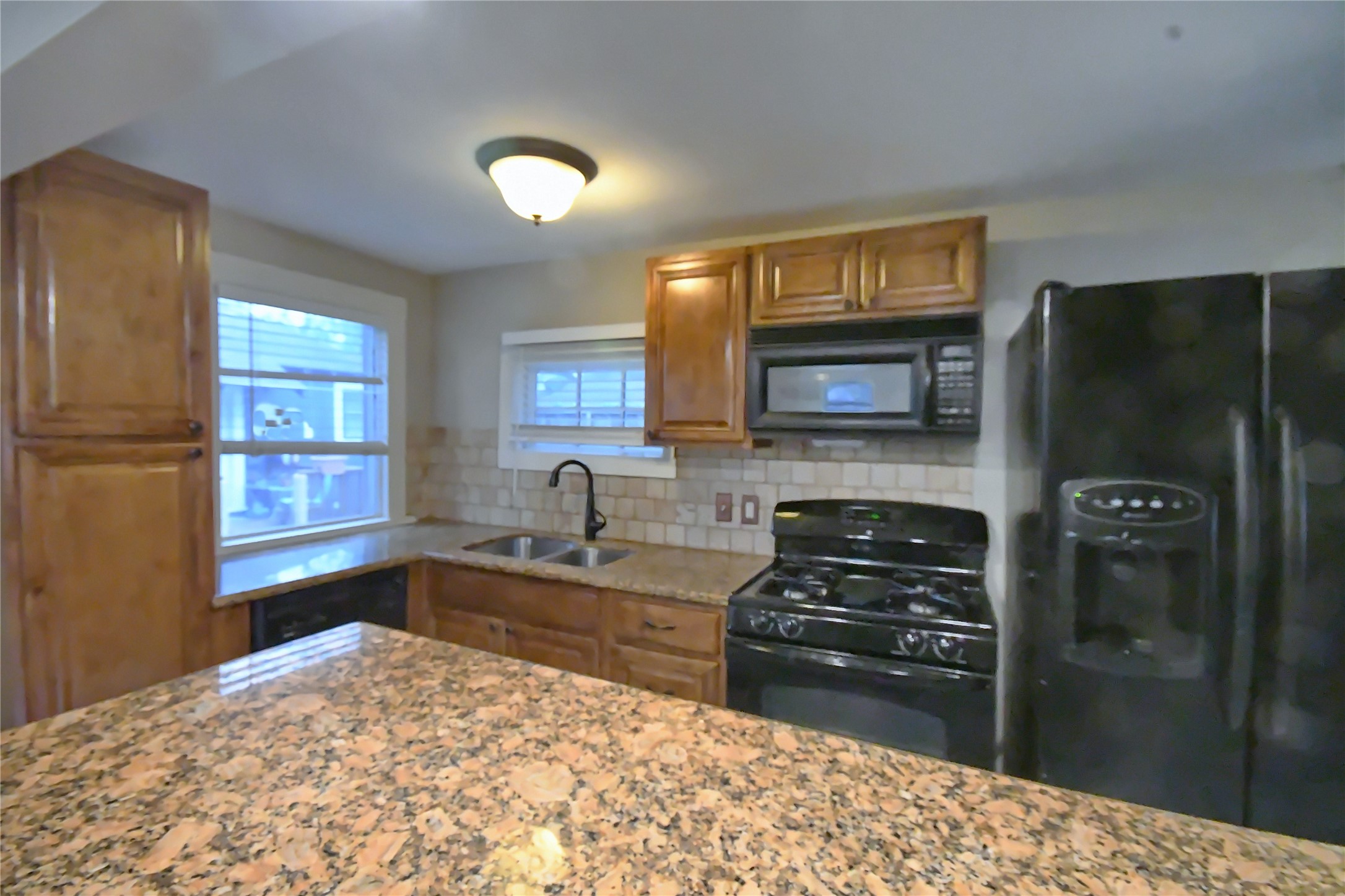 1209 Studewood Street Houston, TX 77008 - Photo 6 of 18 a kitchen with granite countertop a refrigerator stove and sink