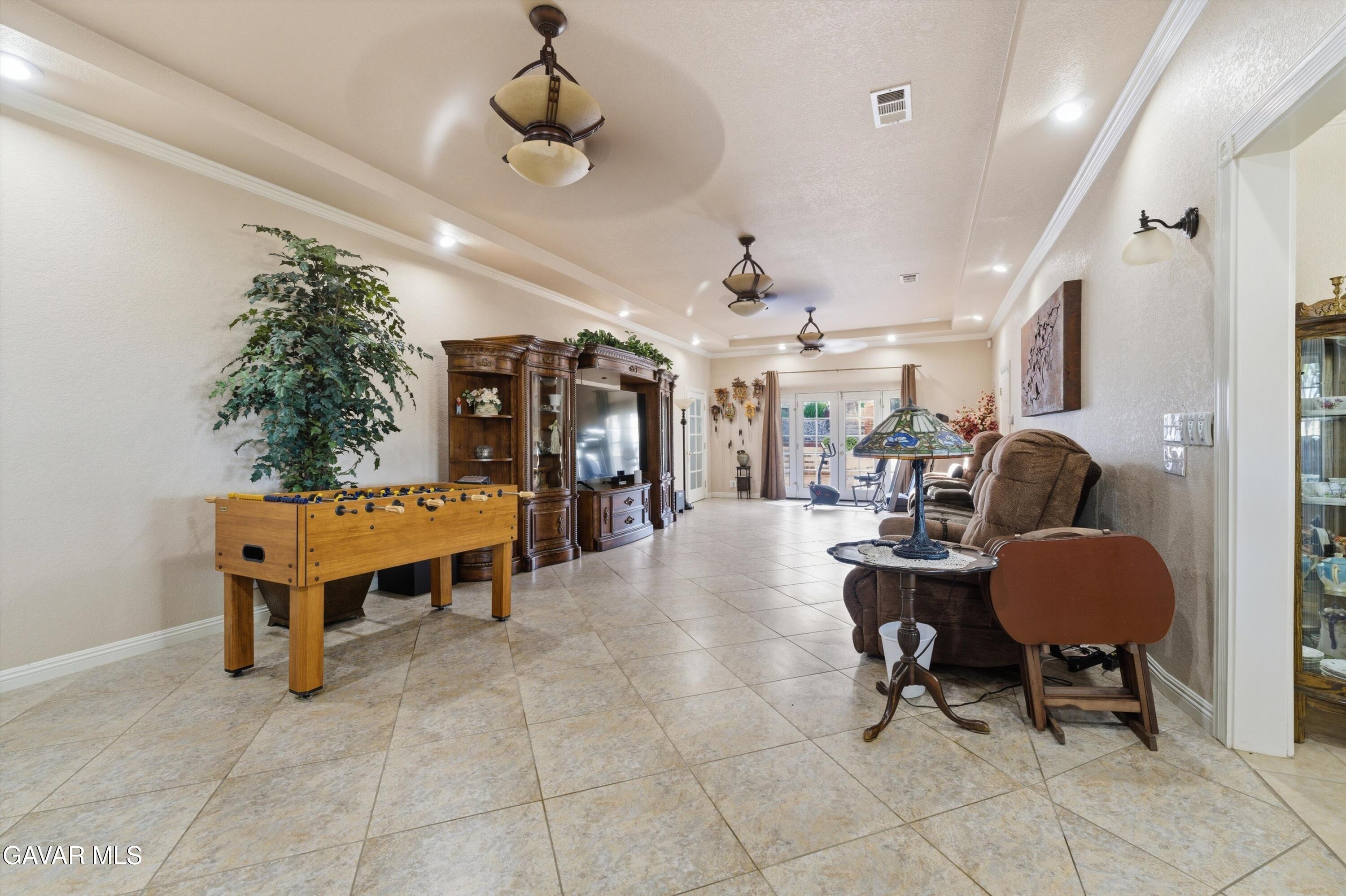 5801 Hacienda Ranch Road Palmdale, CA 93551 - Photo 25 of 69 a dining room with furniture and a chandelier