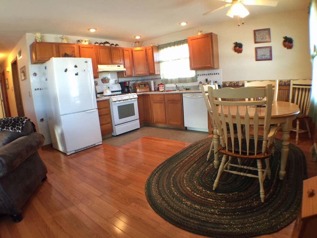 45 Jefferson Street Fall River, MA 02721 - Photo 2 of 16 a view of a kitchen with a window a refrigerator and a dining table