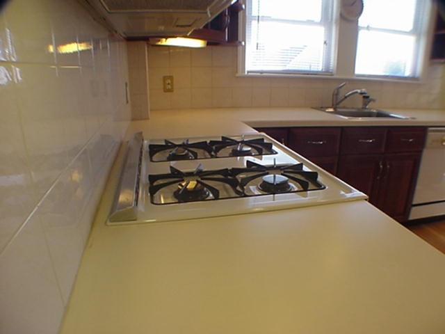 8-10 Kenrick Street, Unit 10 Boston, MA 02135 - Photo 12 of 28 a kitchen with a sink a stove and cabinets