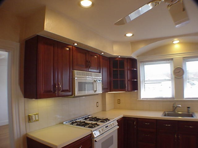 8-10 Kenrick Street, Unit 10 Boston, MA 02135 - Photo 13 of 28 a kitchen with a sink cabinets and window