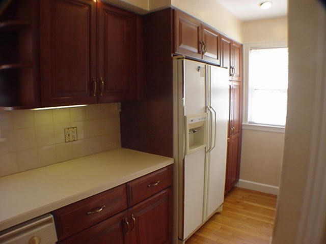 8-10 Kenrick Street, Unit 10 Boston, MA 02135 - Photo 14 of 28 a kitchen with a refrigerator and cabinets
