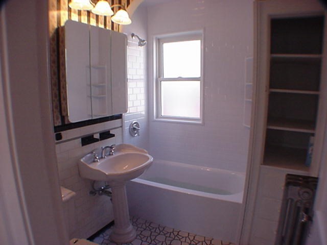 8-10 Kenrick Street, Unit 10 Boston, MA 02135 - Photo 19 of 28 a bathroom with a sink a toilet and bathtub