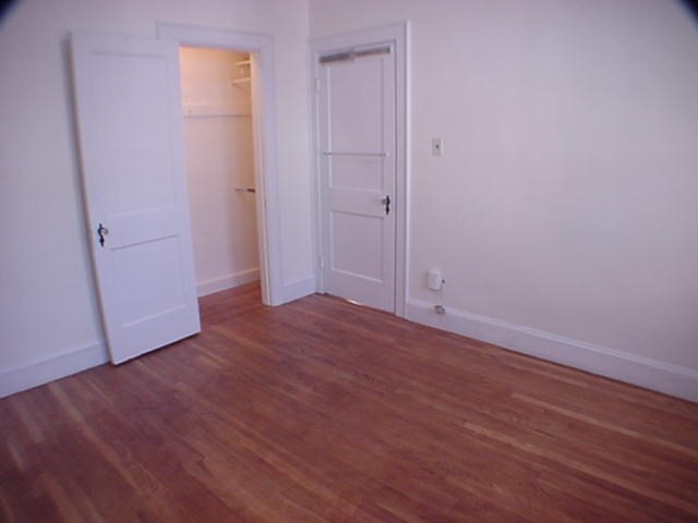 8-10 Kenrick Street, Unit 10 Boston, MA 02135 - Photo 22 of 28 a view of an empty room with wooden floor