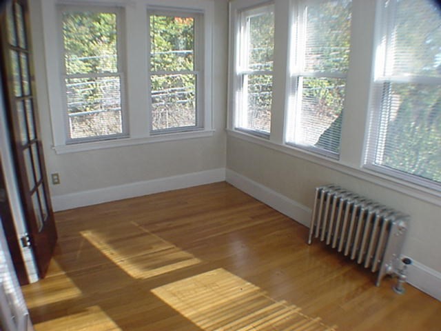 8-10 Kenrick Street, Unit 10 Boston, MA 02135 - Photo 5 of 28 a view of a room with wooden floor and a window