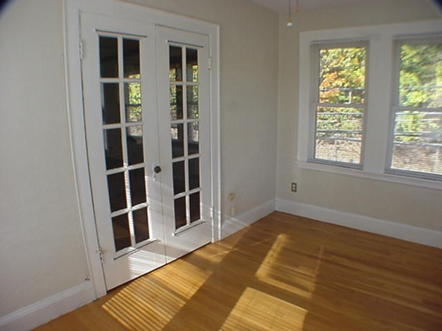 8-10 Kenrick Street, Unit 10 Boston, MA 02135 - Photo 7 of 28 a view of a bedroom with wooden floor and closet