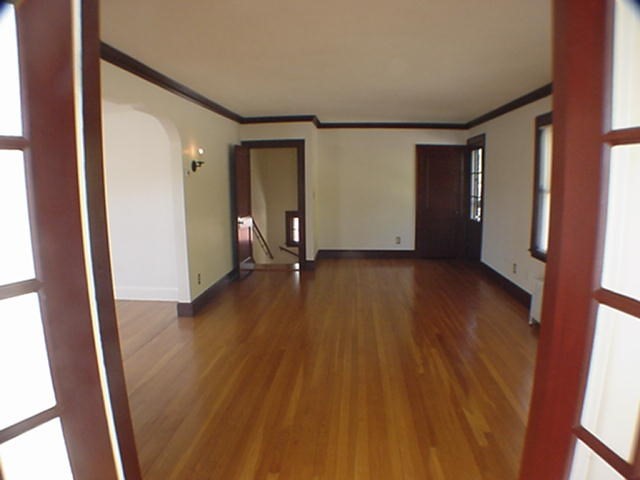 8-10 Kenrick Street, Unit 10 Boston, MA 02135 - Photo 8 of 28 an empty room with wooden floor and windows