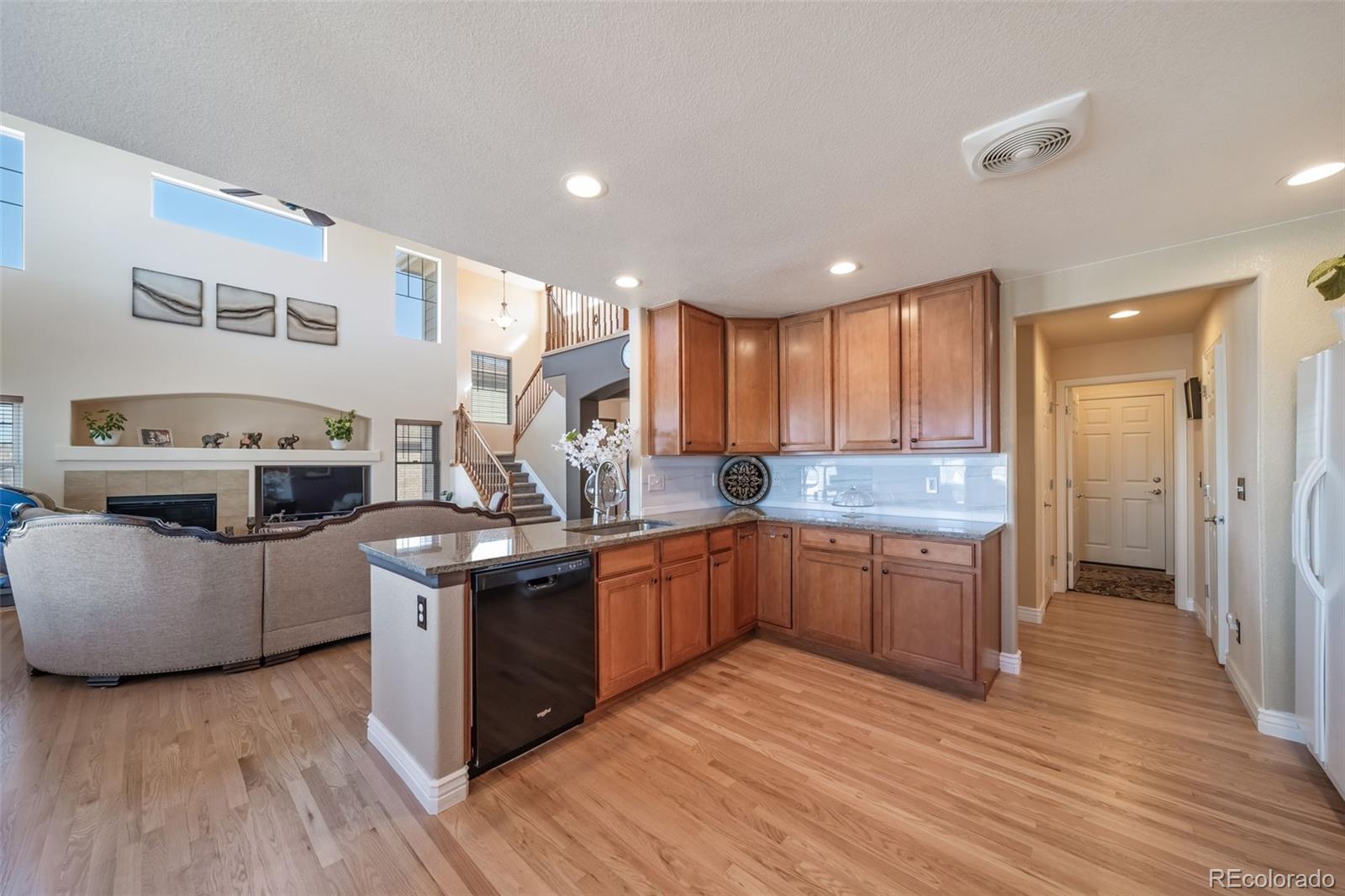3041 South Jericho Way Aurora, CO 80013 - Photo 15 of 46 a kitchen with stainless steel appliances granite countertop a stove and a refrigerator