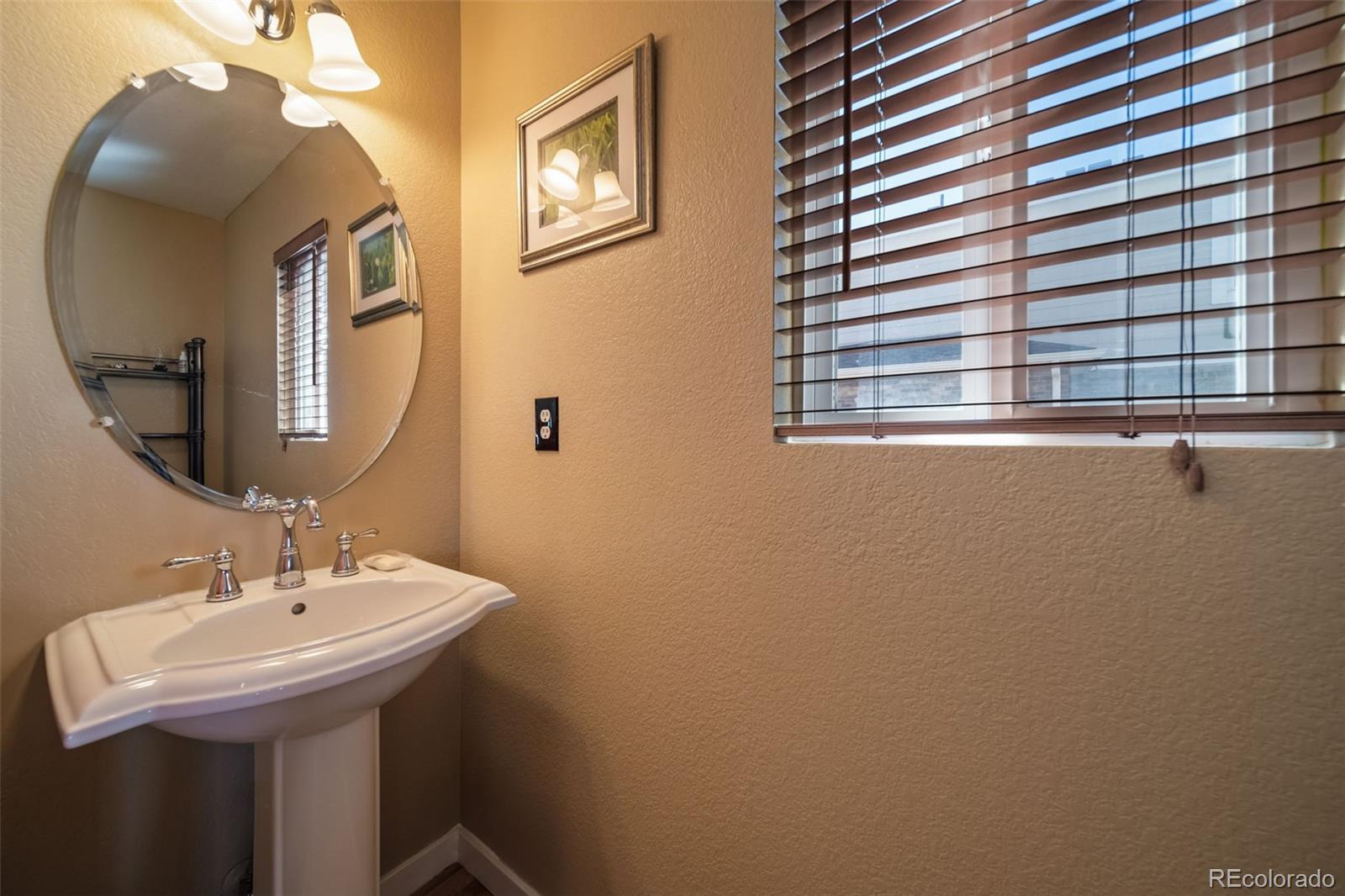 3041 South Jericho Way Aurora, CO 80013 - Photo 19 of 46 a bathroom with a sink a mirror and a window