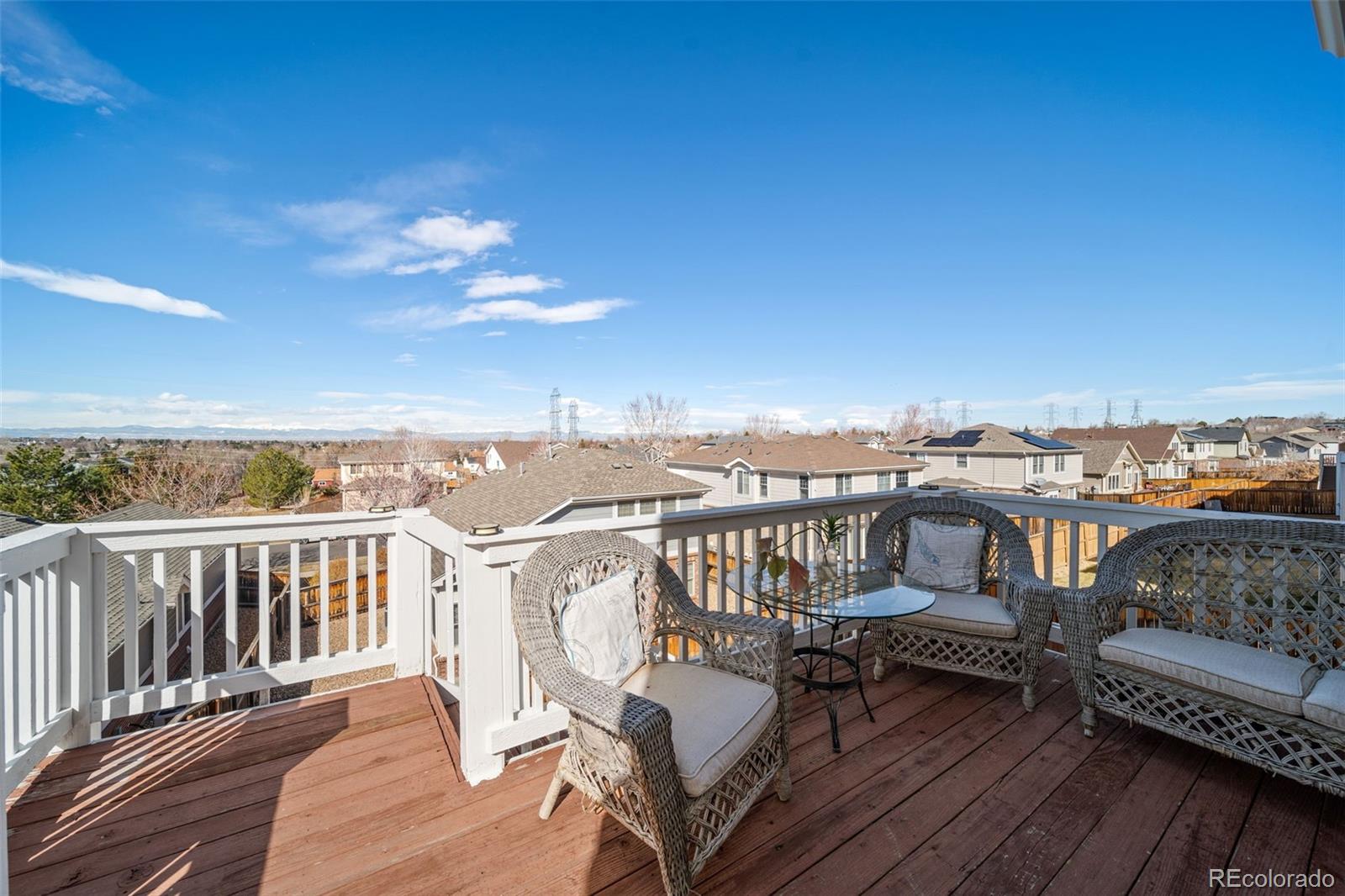 3041 South Jericho Way Aurora, CO 80013 - Photo 22 of 46 a view of a balcony with wooden chairs