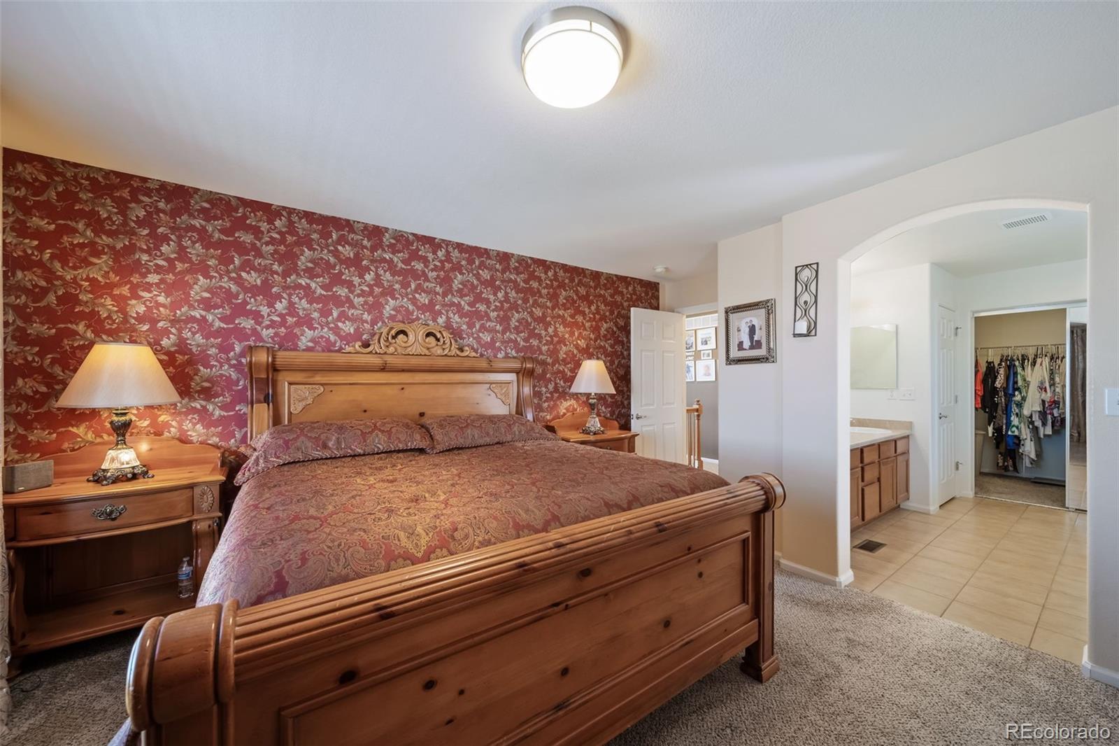 3041 South Jericho Way Aurora, CO 80013 - Photo 27 of 46 a bedroom with a bed and a lamp