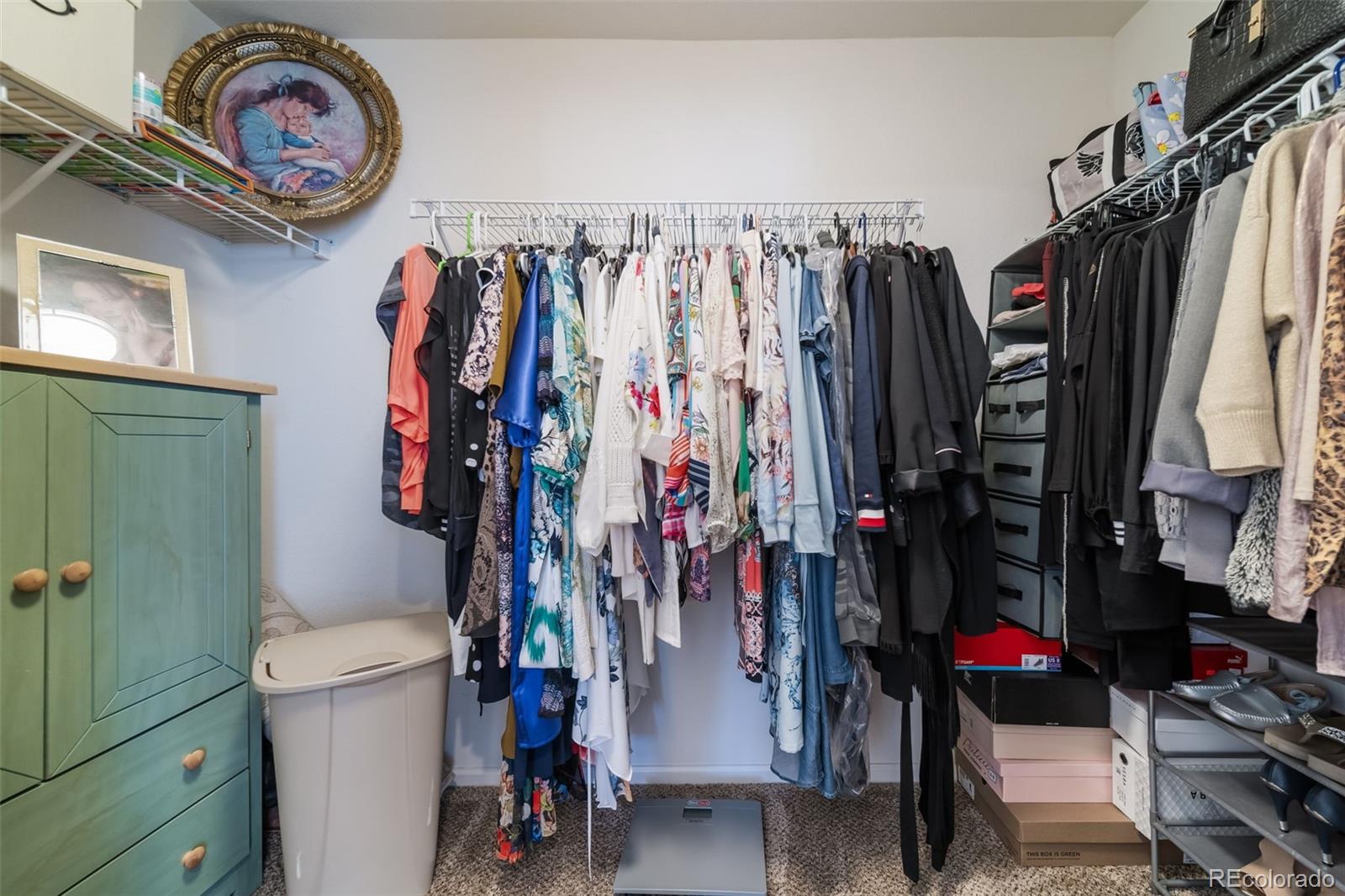 3041 South Jericho Way Aurora, CO 80013 - Photo 31 of 46 a view of walk in closet with clothes and shoes