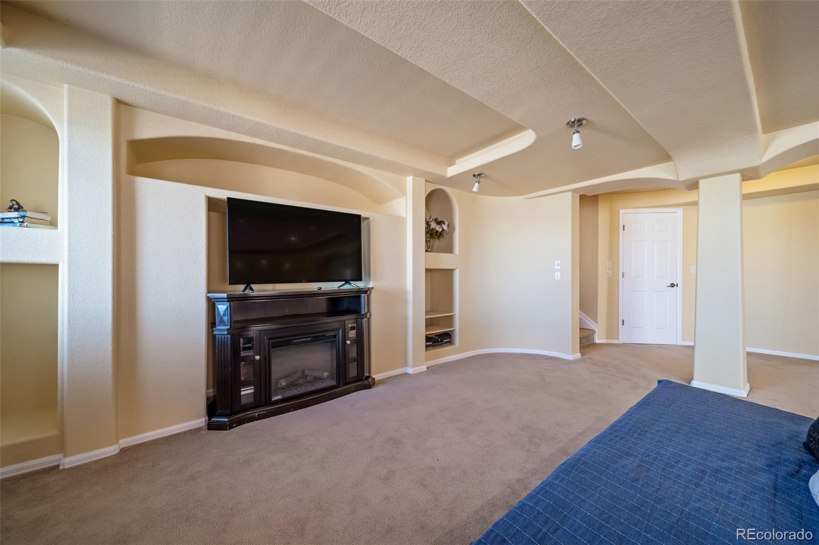 3041 South Jericho Way Aurora, CO 80013 - Photo 37 of 46 a living room with a flat screen tv and a fireplace