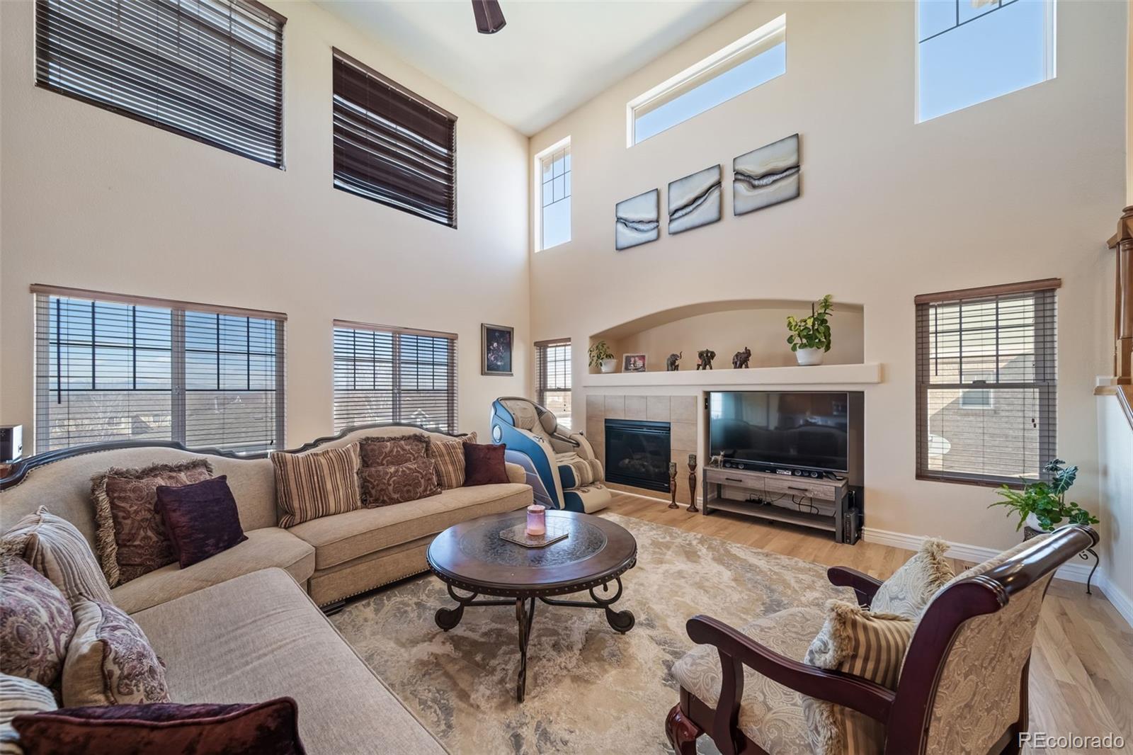 3041 South Jericho Way Aurora, CO 80013 - Photo 7 of 46 a living room with furniture flat screen tv and a fireplace