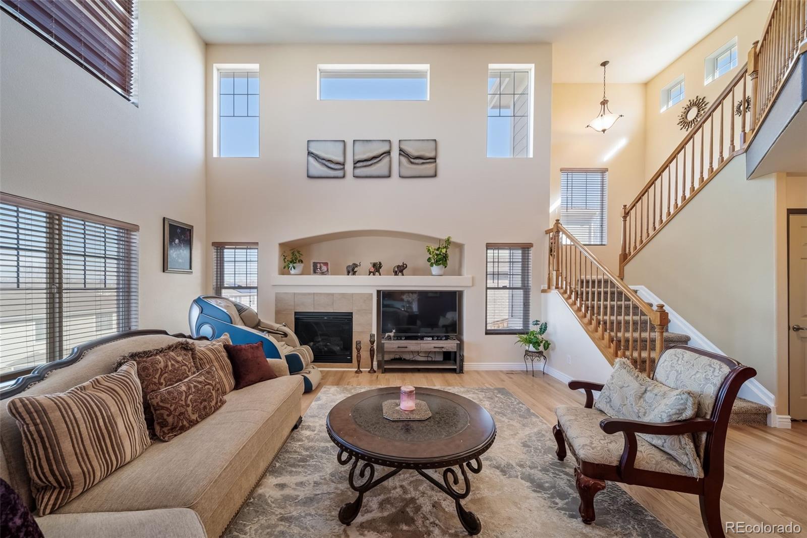 3041 South Jericho Way Aurora, CO 80013 - Photo 8 of 46 a living room with furniture a fireplace and a large window