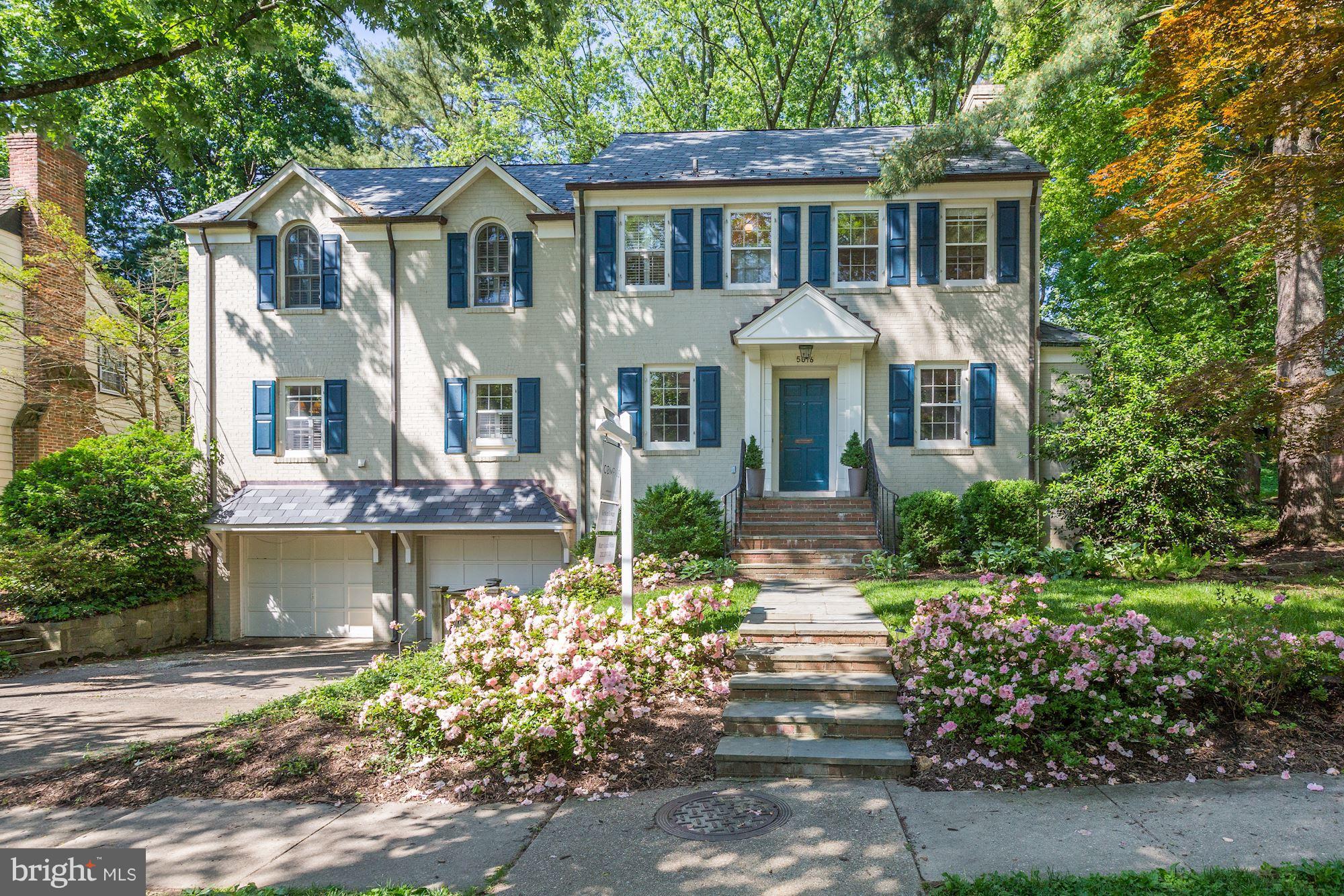 5016 Baltan Road Bethesda, MD 20816 - Photo 1 of 1 a front view of a house with a garden and fountain