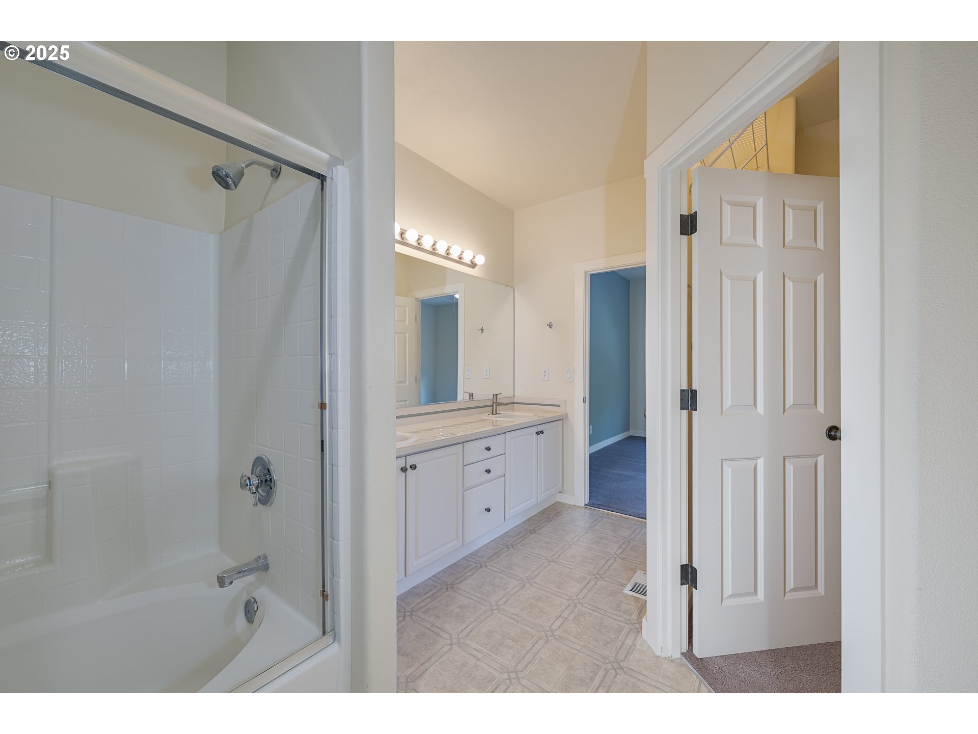 384 Southwest 105th Terrace Portland, OR 97225 - Photo 12 of 30 a bathroom with a granite countertop sink a mirror a bathtub and shower
