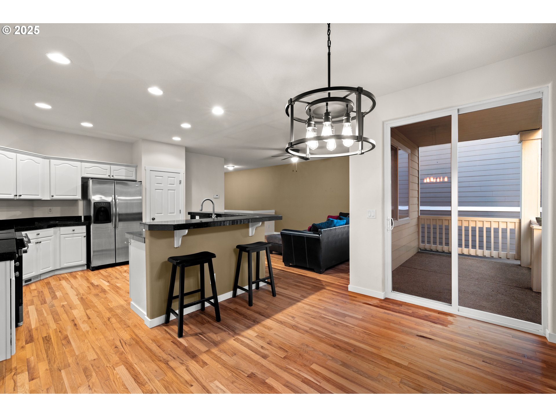 384 Southwest 105th Terrace Portland, OR 97225 - Photo 4 of 30 a view of a dining room and livingroom with furniture wooden floor a chandelier