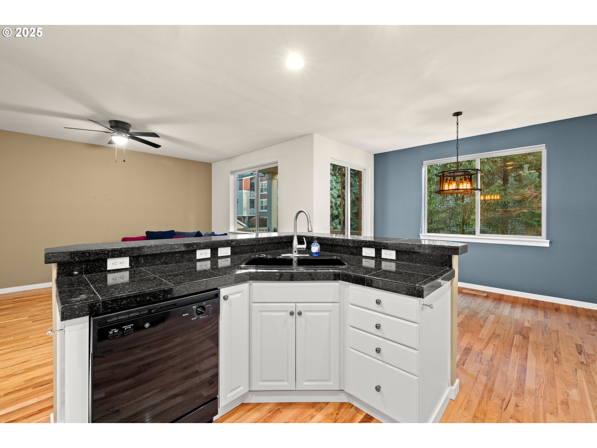 384 Southwest 105th Terrace Portland, OR 97225 - Photo 5 of 30 a kitchen with granite countertop a sink cabinets and window