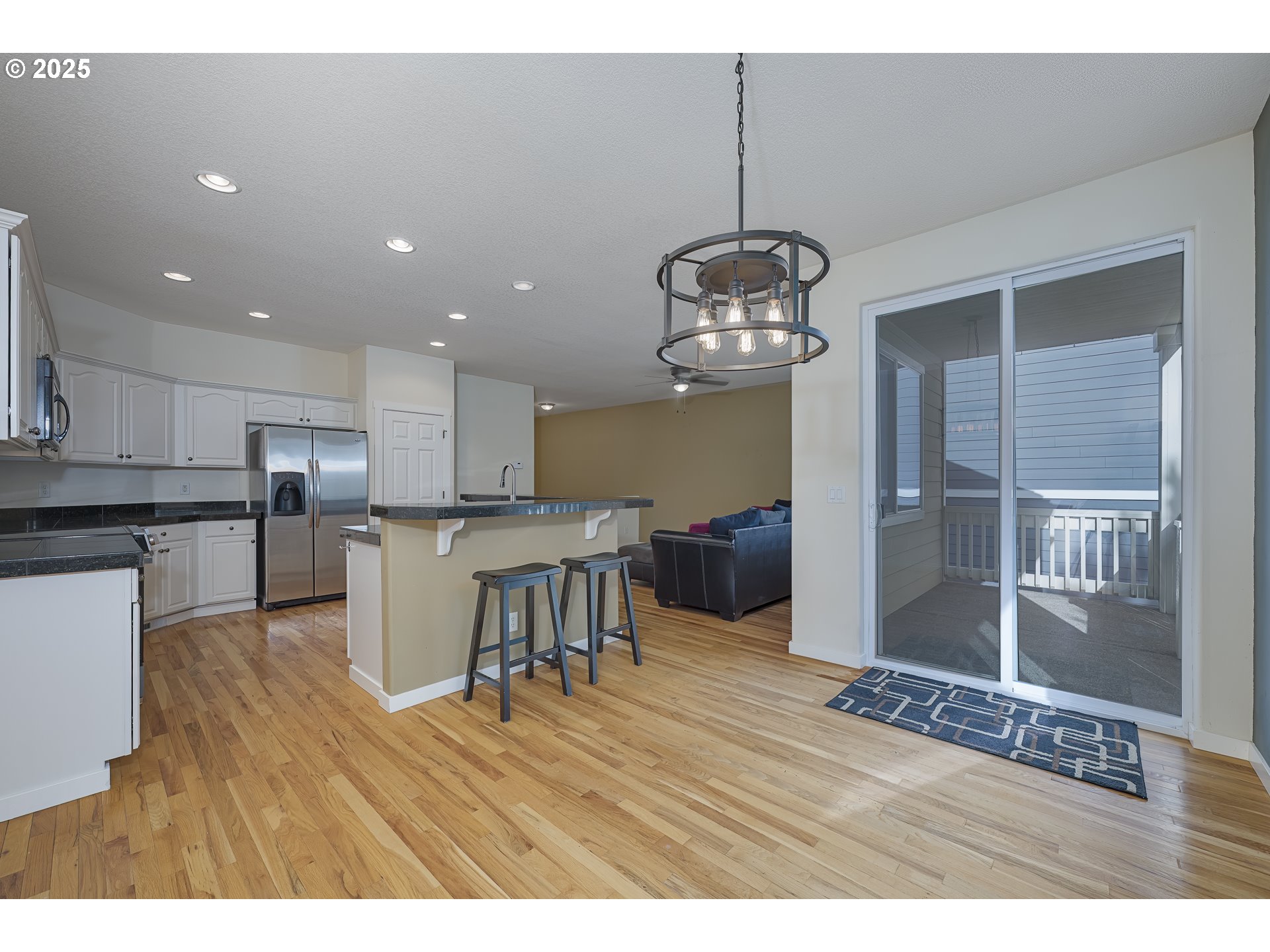 384 Southwest 105th Terrace Portland, OR 97225 - Photo 6 of 30 a view of a dining room and livingroom with furniture wooden floor a chandelier