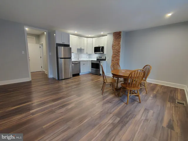 a living room with furniture and kitchen view