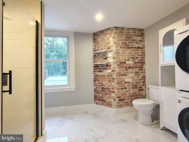a bathroom with a toilet and a shower curtain