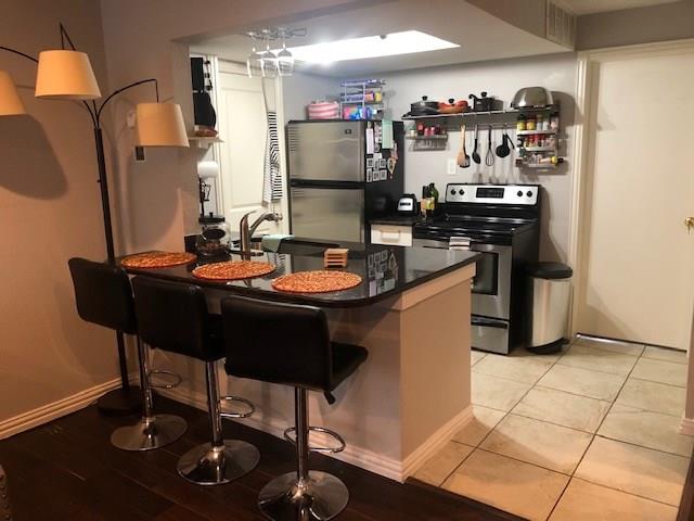 2400 Jupiter Road, Unit F 1 Plano, TX 75074 - Photo 1 of 1 a kitchen with a table and chairs in it