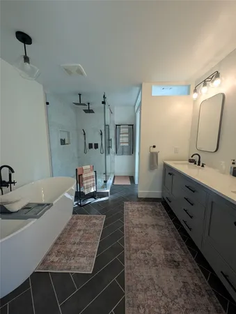 a spacious bathroom with a double vanity sink and a mirror