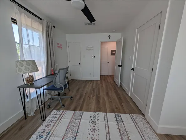 a view of a room with wooden floor and windows